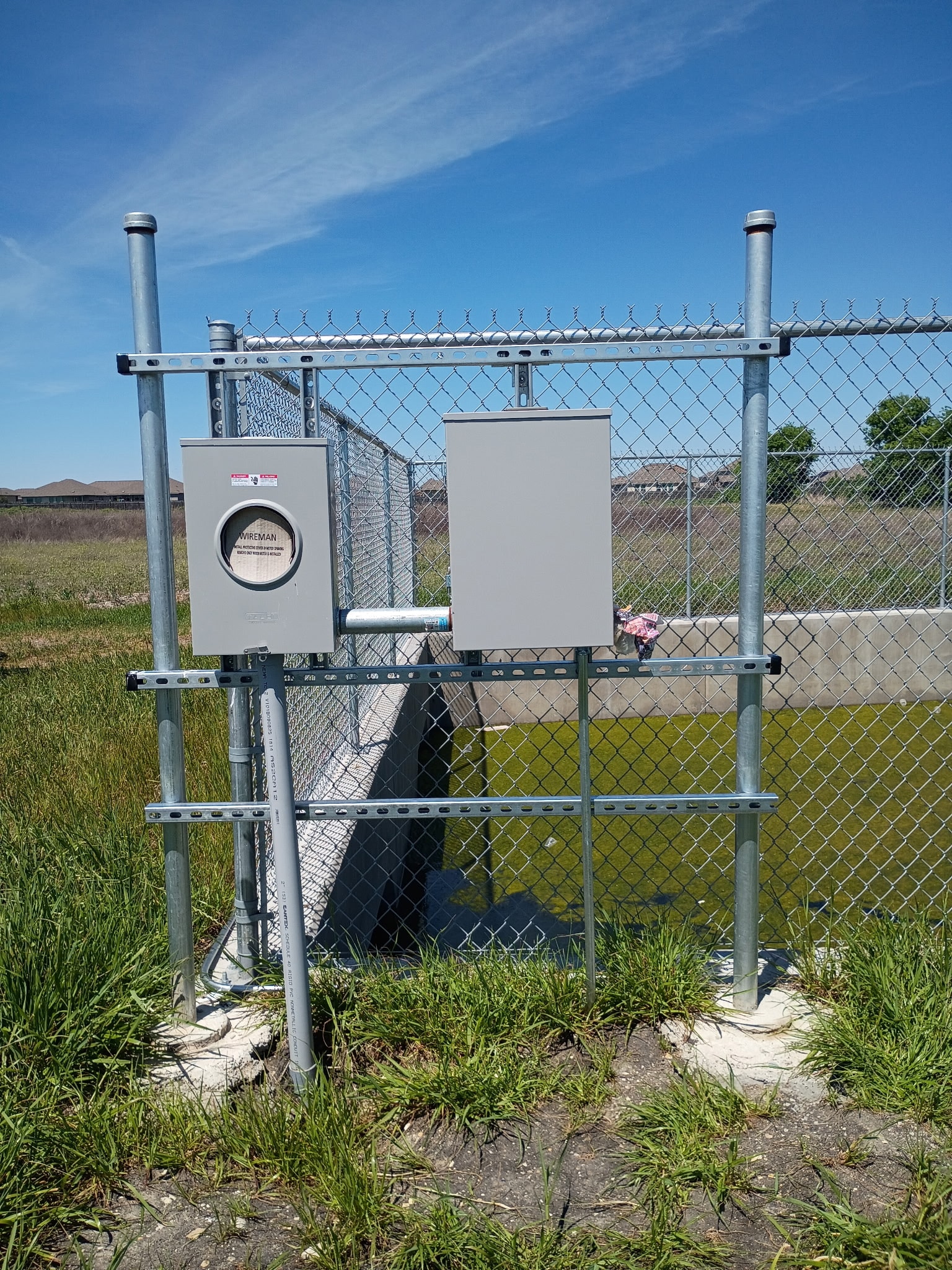 Outdoor meter enclosure and control box at retention pond